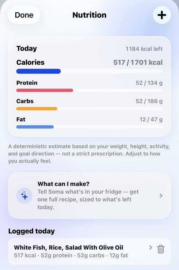 SOMA Nutrition screen on iPhone: 517 of 1,701 kcal eaten with 1,184 left, protein 52 of 134 g, carbs 52 of 186 g, fat 12 of 47 g, a “What can I make?” card inviting you to tell Soma what’s in your fridge, and a logged meal of white fish, rice and salad.